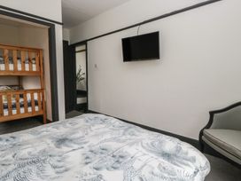 A bedroom with a bed and bunk bed at Herdwick Croft in Bassenthwaite