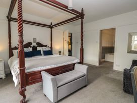A bedroom with a four-poster bed and a couch at Herdwick Croft in Bassenthwaite