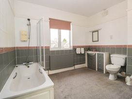 A bathroom with bathtub, toilet, sink and radiator at Herdwick Croft in Bassenthwaite