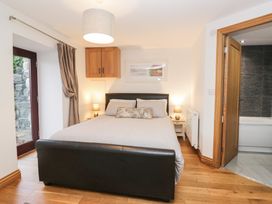 A bedroom with a bed and bedside tables at Newlands Cottage in Keswick