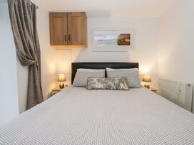 A bedroom with a bed and lamps beside it at Newlands Cottage in Keswick