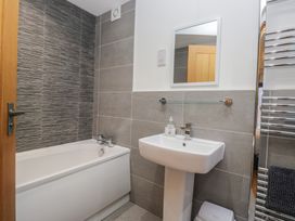 A bathroom with a bathtub and sink at Newlands Cottage in Keswick