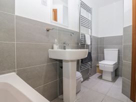 A bathroom with a sink, toilet, and towel rail at Newlands Cottage in Keswick