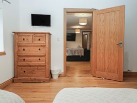 A bedroom with a dresser and television at Newlands Cottage in Keswick