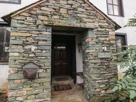 An entrance with a stone wall and door at Birkbank Farm in Cockermouth