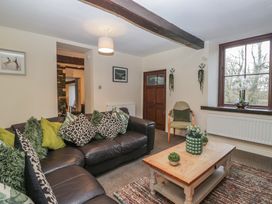 A living room with a sofa and coffee table at Birkbank Farm in Cockermouth