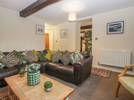 A living room with a sofa and coffee table at Birkbank Farm in Cockermouth