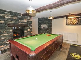 A snug with a billiard table and a fireplace at Birkbank Farm in Cockermouth