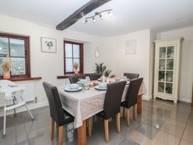 A dining room with a table set for dinner at Birkbank Farm in Cockermouth