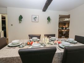 A dining table set with plates and glasses at Birkbank Farm Cockermouth