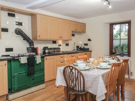 A kitchen with a table set for dinner at Birkbank Farm in Cockermouth