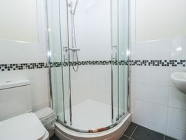 A bathroom with a shower, toilet, and sink at Birkbank Farm in Cockermouth