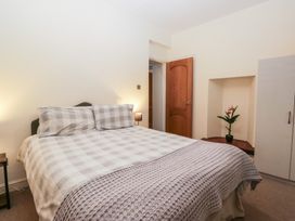 A bedroom with a bed and a plant at Birkbank Farm in Cockermouth