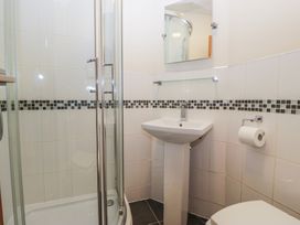 A bathroom with a shower, sink, and toilet at Birkbank Farm in Cockermouth