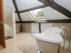 A bathroom with a bathtub and skylight at Birkbank Farm Cockermouth
