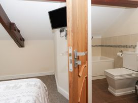 A bathroom with a bath tub and toilet at Birkbank Farm Cockermouth
