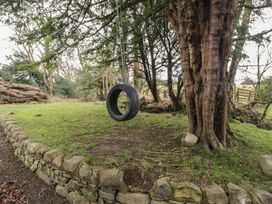 A tire swing hanging from a tree in an outdoor area at Birkbank Farm Cockermouth
