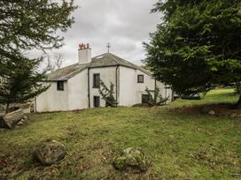 A house surrounded by grass and trees at Birkbank Farm in Cockermouth