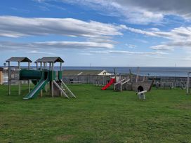 A playground with slides and climbing structures at Red Lion Caravan Park