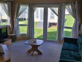 A living room with a sofa and coffee table at Red Lion Caravan Park