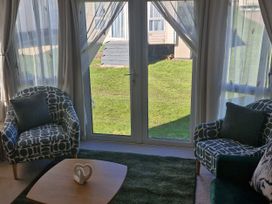 A snug area with two chairs and a table at Red Lion Caravan Park, Arbroath