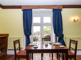 A dining room with a table set for meals at Dowrich West Wing Apartment in Crediton