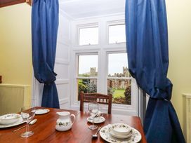 A dining room table set with dishes and a view at Dowrich West Wing Apartment in Crediton