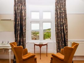 A sitting room with chairs and a table at Dowrich West Wing Apartment in Crediton