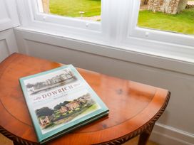 A book on a table near a window at Dowrich West Wing Apartment in Crediton