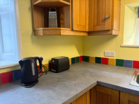 A kitchen with a kettle, toaster, and grater at Dowrich West Wing Apartment near Sandford, Devon