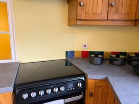 A kitchen with a cooker and pots at Dowrich West Wing Apartment near Sandford, Devon