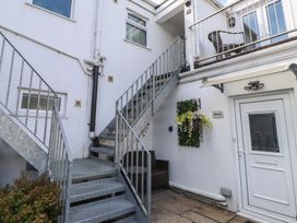 An outdoor area with stairs leading to a door at Flat 1