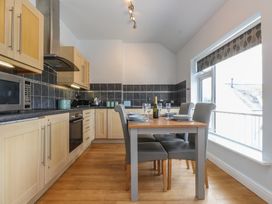 A kitchen with dining table and chairs at Flat 1
