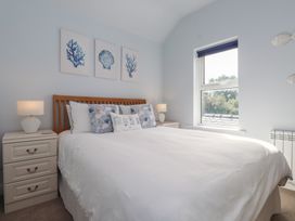 A bedroom with a bed and art on the wall at Flat 1