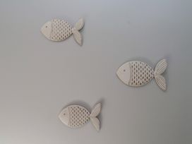 Decorative fish arrangement on a wall at Flat 1