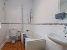 A bathroom with a bathtub and shower at Flat 1