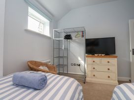 A bedroom with a bed and a television at Flat 1 in 