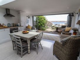 A kitchen with dining table and chairs at Mariners Cottage in Bideford