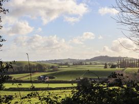 A view of fields and a house surrounded by trees at The Old Telephone Exchange in Exeter