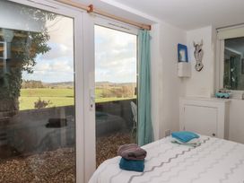 A bedroom with a bed and towels on the side at The Old Telephone Exchange in Exeter
