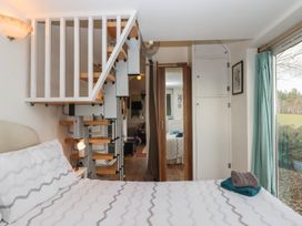 A bedroom with a bed and stairs at The Old Telephone Exchange Exeter