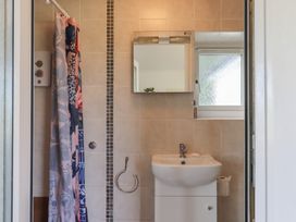 A bathroom with a shower and sink at The Old Telephone Exchange in Exeter