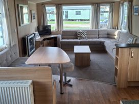 A living room with a sofa and table at Caravan