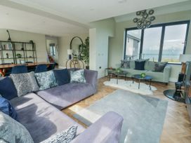 A living room with a sofa and coffee table at Pengarnedd in Amlwch