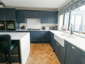 A kitchen with cabinets and a sink at Pengarnedd in Amlwch