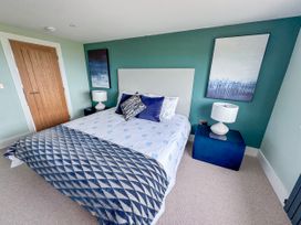 A bedroom with a bed and two bedside tables at Pengarnedd in Amlwch