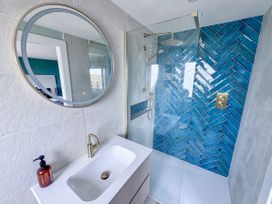 A bathroom with a shower and sink at Pengarnedd in Amlwch