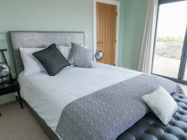 A bedroom with bed and pillows at Pengarnedd in Amlwch