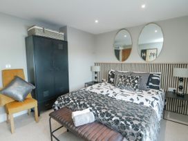 A bedroom with a bed and storage cabinet at Pengarnedd in Amlwch