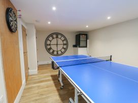 A game room with a table tennis table and dartboard at Pengarnedd in Amlwch